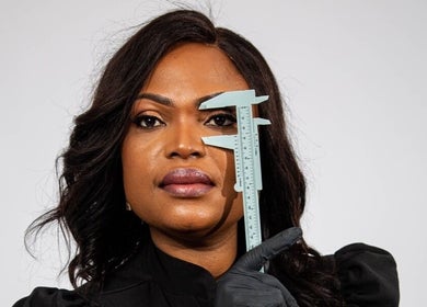 Expert measuring eyebrow with caliper at Ndila Beauty Academy, Manchester, England, GB.