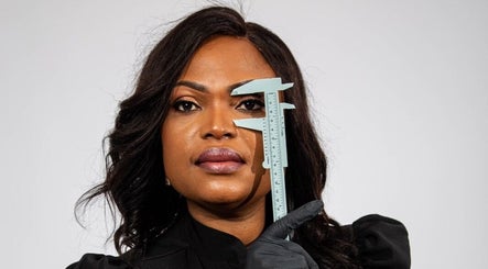 Expert measuring eyebrow with caliper at Ndila Beauty Academy, Manchester, England, GB.