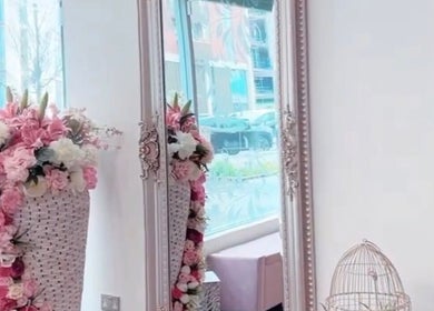Charming floral arrangement in elegant mirror at Ndila Beauty Academy, Manchester, England, GB.
