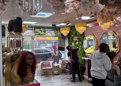 Interior of Ndila Beauty Academy, Manchester, England, GB showcasing elegant decor and hair styling in progress.