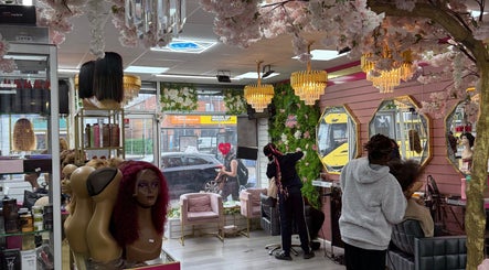 Interior of Ndila Beauty Academy, Manchester, England, GB showcasing elegant decor and hair styling in progress.