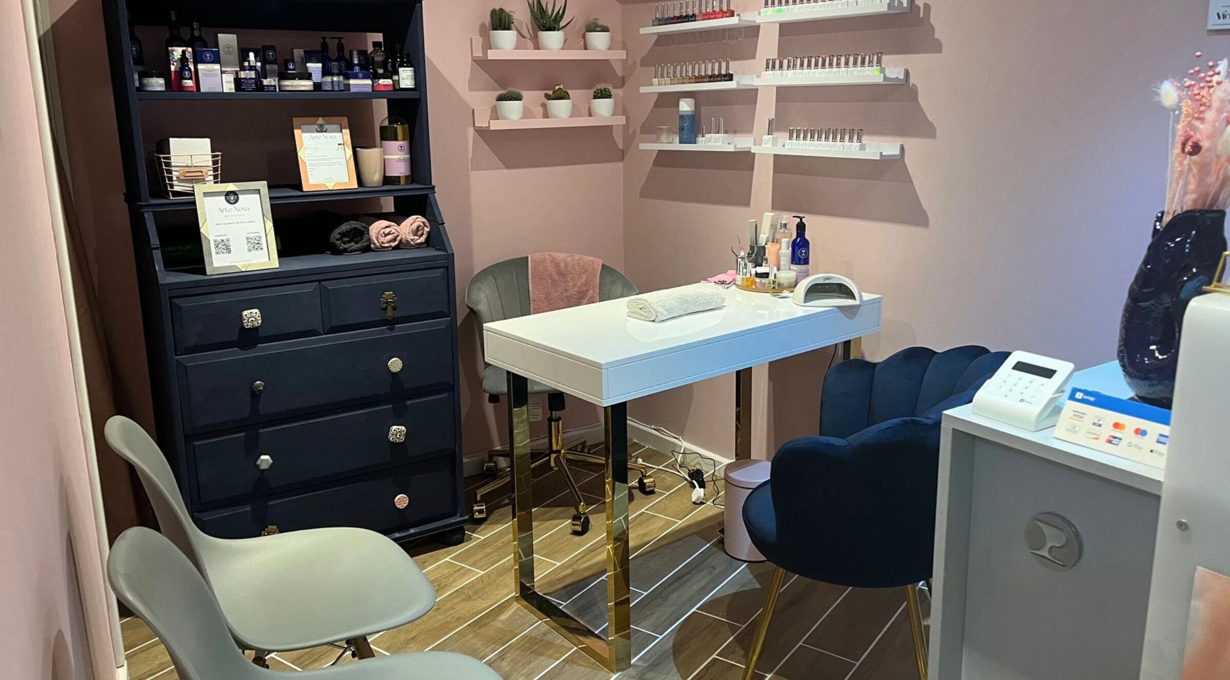 Elegant nail bar setup at Arte Nova, Barnet, England, GB, featuring chic decor and nail polish display.