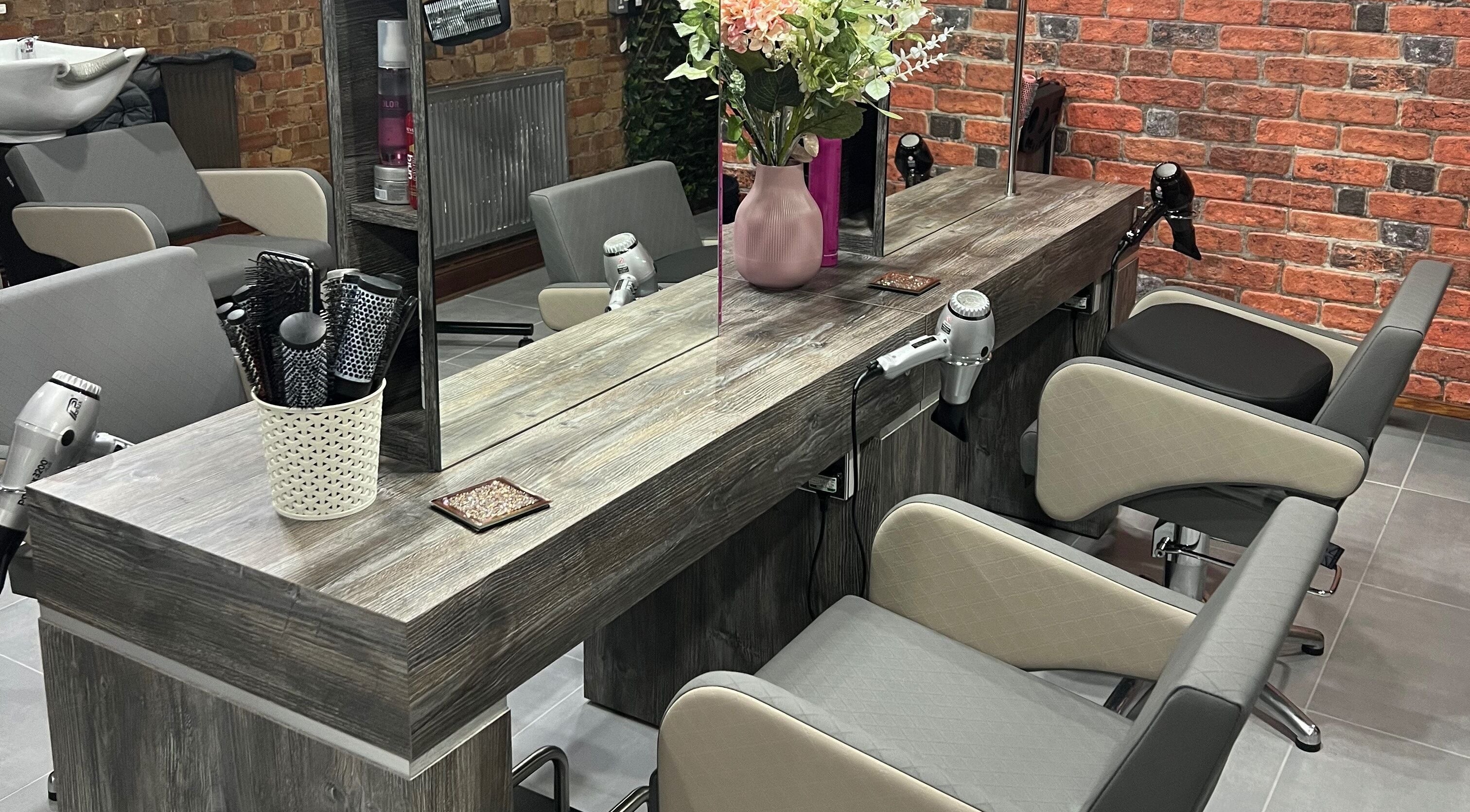 Modern salon chairs and hair styling tools at Ultimate Hair and Nails, London, England, GB.