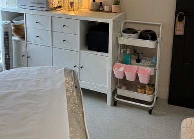 A tranquil treatment room at The Solar Skin Club Ramsgate in Ramsgate, England, GB, with organized shelving.