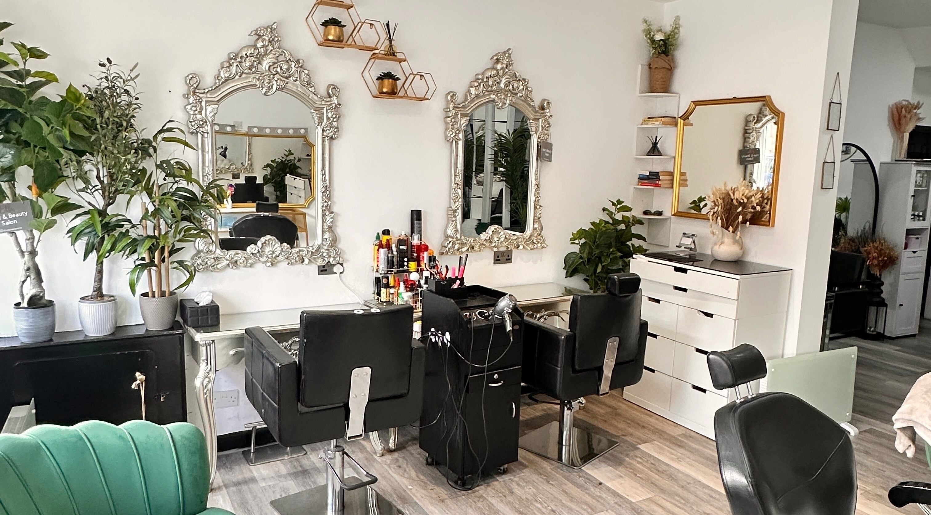 Chic interior of Ella Hair and Beauty Salon, Liverpool, England, GB, showcasing ornate mirrors and stylish chairs.