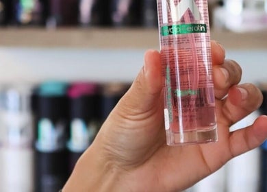 Hand holding serum bottle at The Glam Bar, Hair, Nails, Skin, Lash Beauty Bar, Cape Town, Western Cape, ZA.