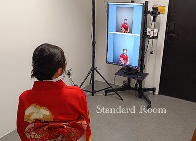 A person in a red kimono sits before a photo setup at Photonow @ Centrepoint, Singapore, Singapore, SG.