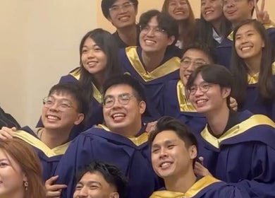 A group of graduates celebrating at Photonow @ Centrepoint, Singapore, Singapore, SG, wearing blue and gold robes.