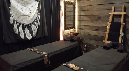 Peaceful spa room at Inka Spa Bali, Bali, ID with twin massage tables and rustic decor.