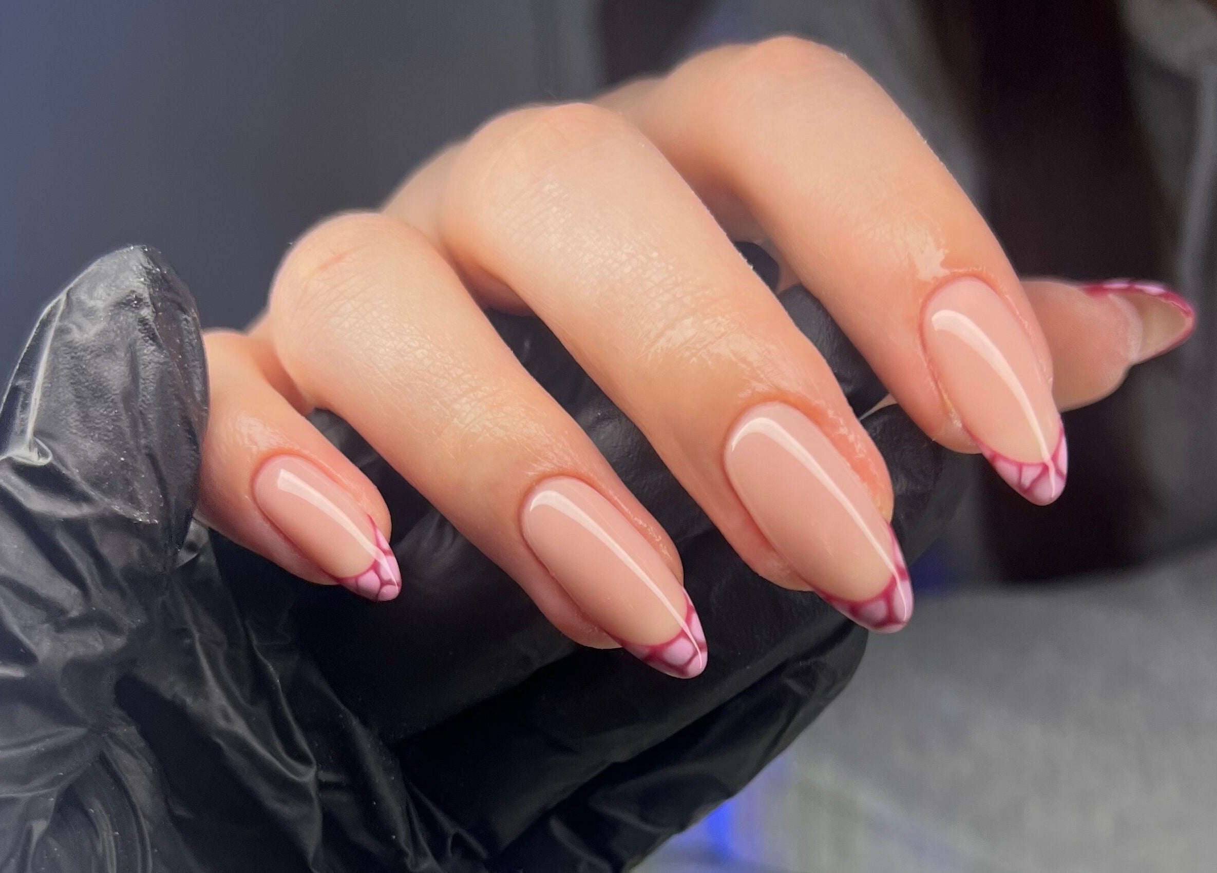 Stylish pink nail art design at Byleahhm, Osgodby, England, GB showcasing precise manicure techniques.