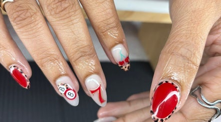 Colorful nail art featuring cherries and numbers at The Lab ltd, London, England, GB. Beautiful manicure design.