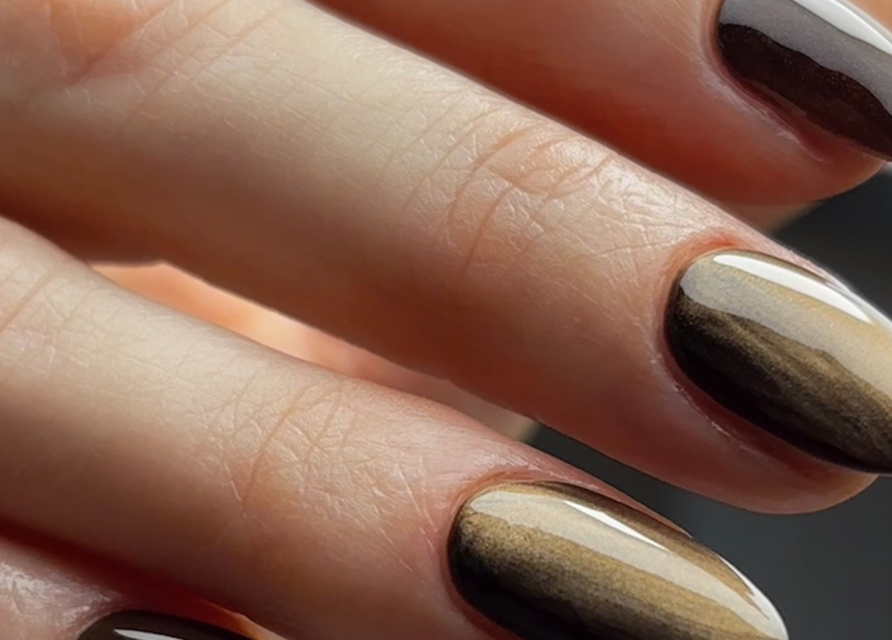 Beautifully manicured nails at Beauty Haven by Jodie, Caerphilly, Wales, GB. Elegant brown tones showcased.