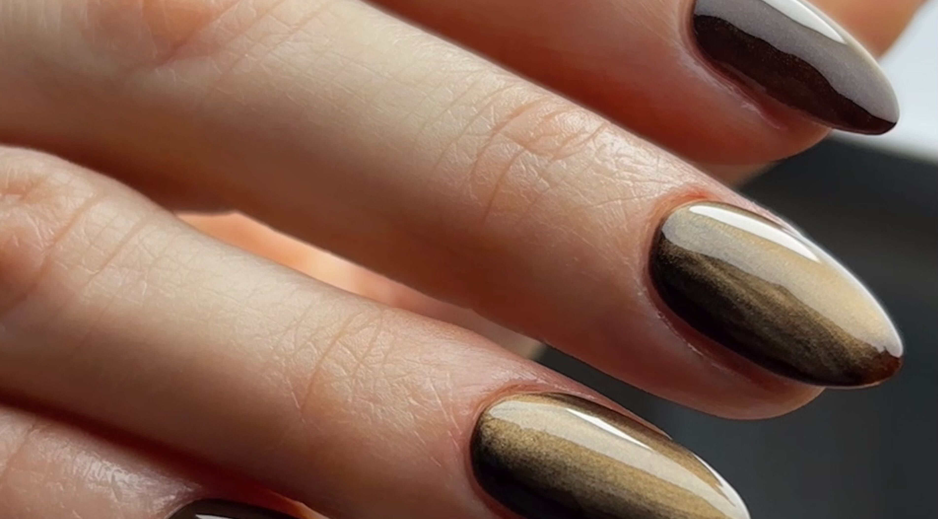 Beautifully manicured nails at Beauty Haven by Jodie, Caerphilly, Wales, GB. Elegant brown tones showcased.