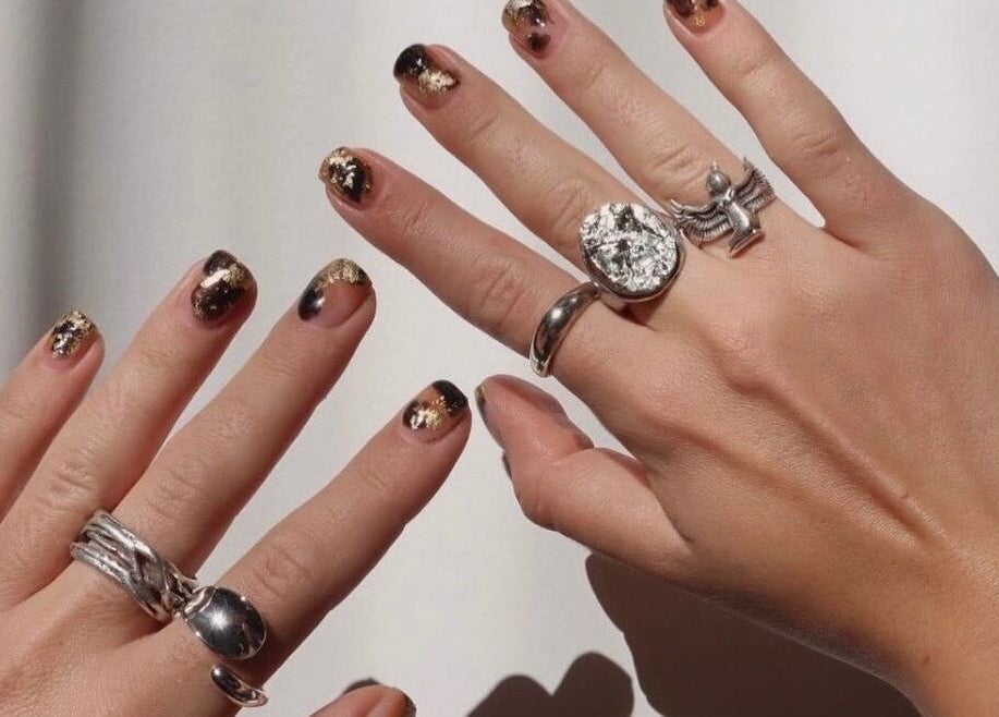 Stylish black and gold nails at Raglan Nails, Raglan, Waikato, NZ. Perfect for a glamorous look.