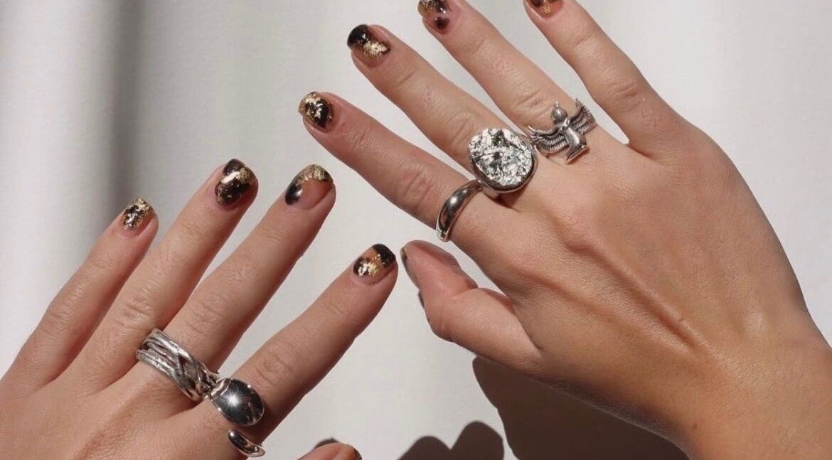Stylish black and gold nails at Raglan Nails, Raglan, Waikato, NZ. Perfect for a glamorous look.