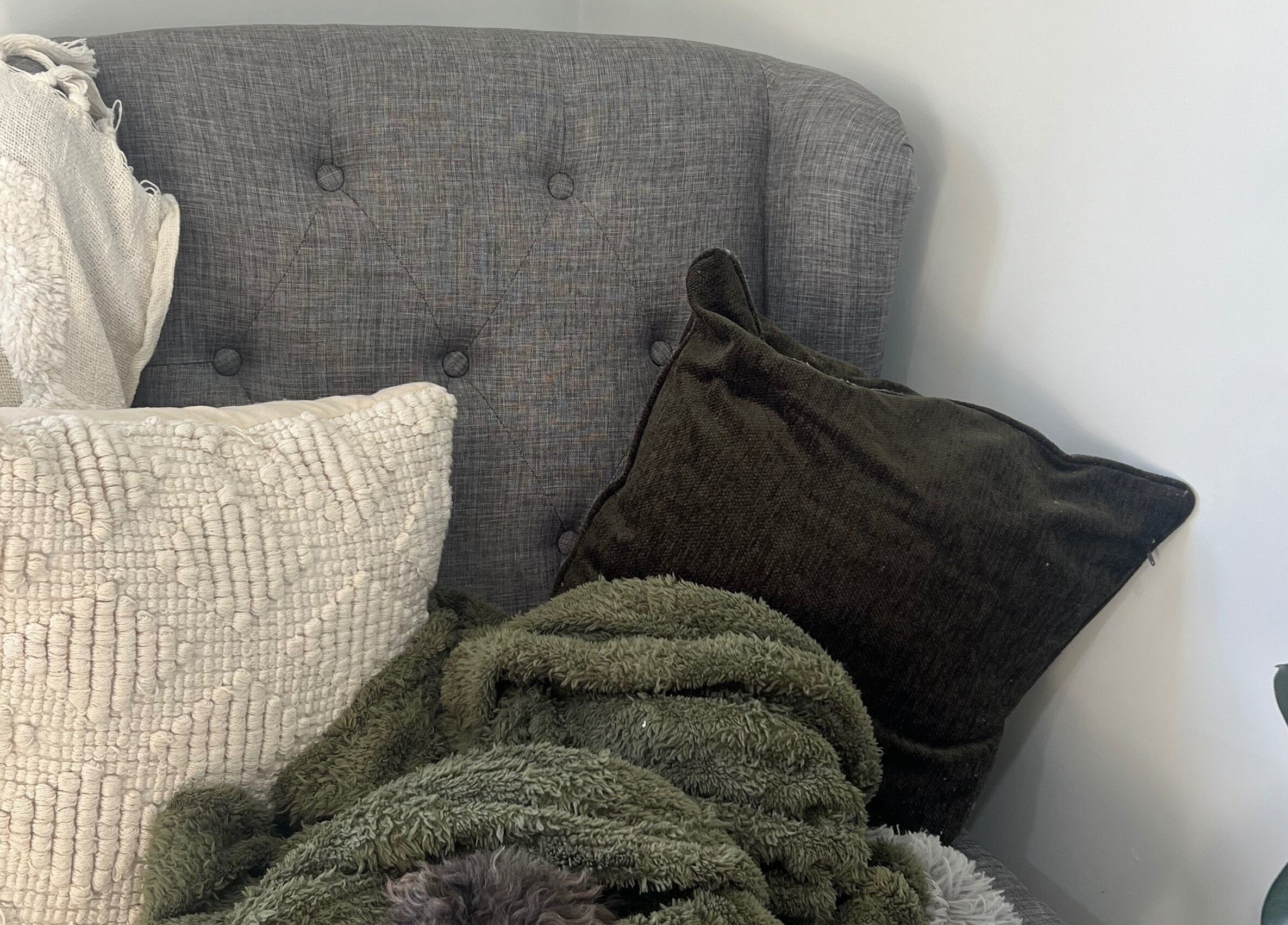 Comfortable seating with plush pillows at Raglan Nails in Raglan, Waikato, NZ.