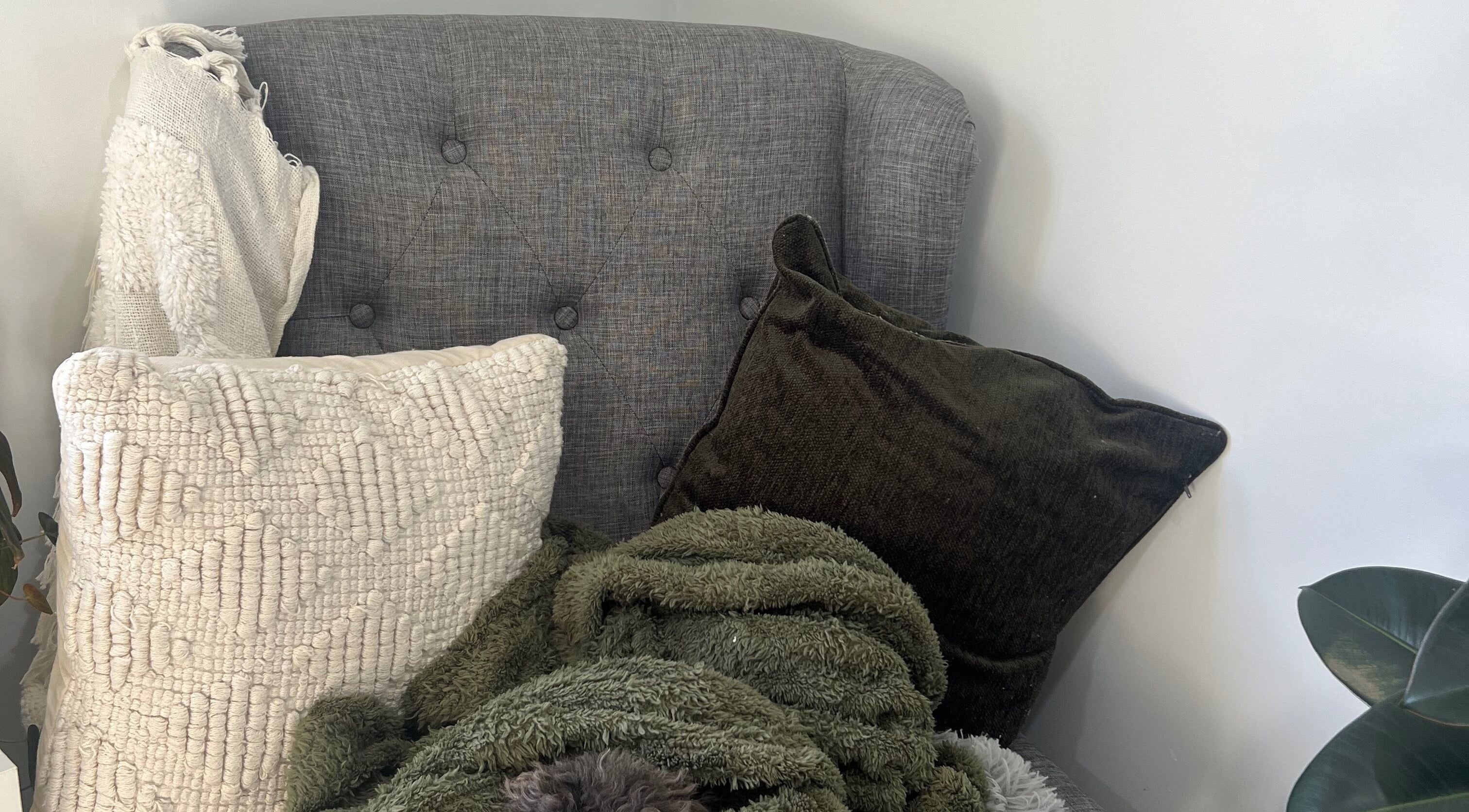 Comfortable seating with plush pillows at Raglan Nails in Raglan, Waikato, NZ.