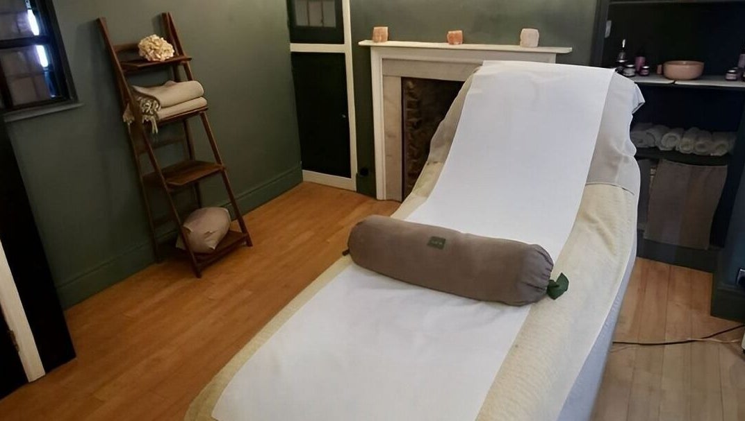 Relaxing treatment room at Orb Retreat, Uppingham, England, GB showcasing a massage table and serene decor.