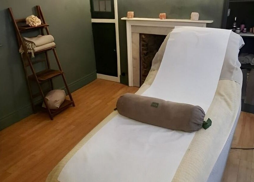 Relaxing treatment room at Orb Retreat, Uppingham, England, GB showcasing a massage table and serene decor.