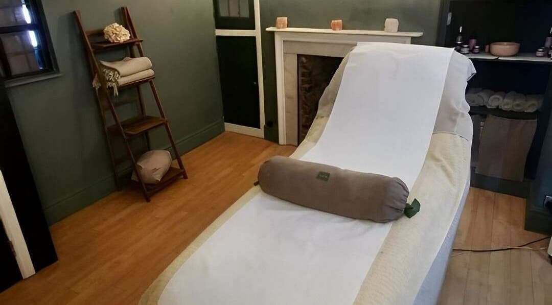 Relaxing treatment room at Orb Retreat, Uppingham, England, GB showcasing a massage table and serene decor.