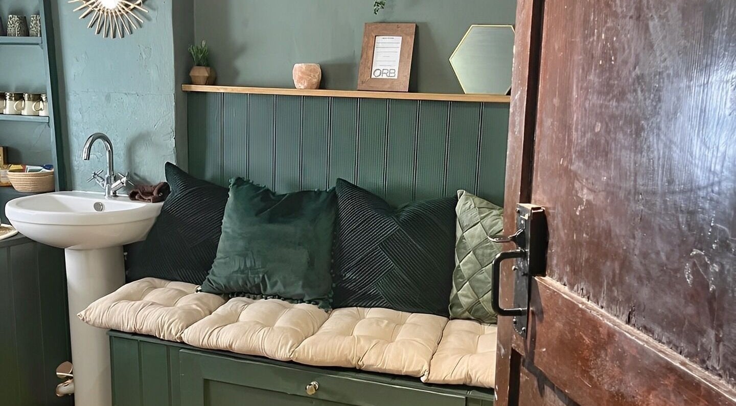 Inviting seating and sink at Orb Retreat, Uppingham, England, GB. Relaxing, cozy interior decor.