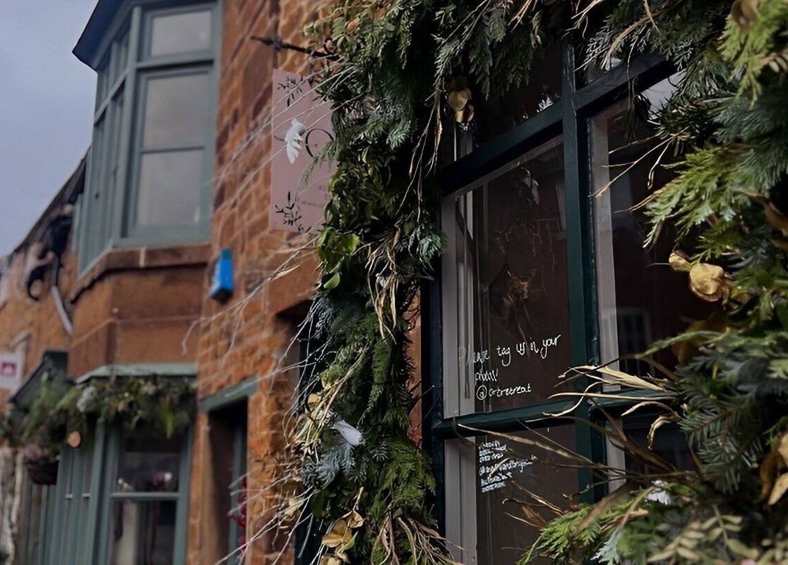 Leafy green decor adorns the historic facade of Orb Retreat in Uppingham, England, GB.