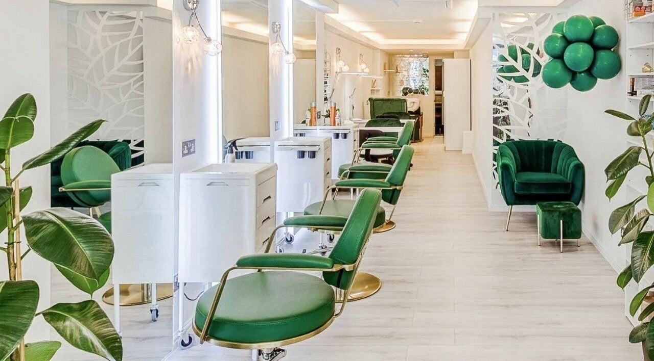 Chic interior of Body La Perla salon, London, England, GB, featuring elegant green seating and stylish decor.
