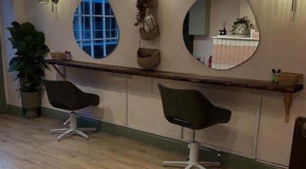 Chic salon seating at Nicole at Sage and Blush, Grantham, England, GB. Modern mirrors and comfortable chairs.
