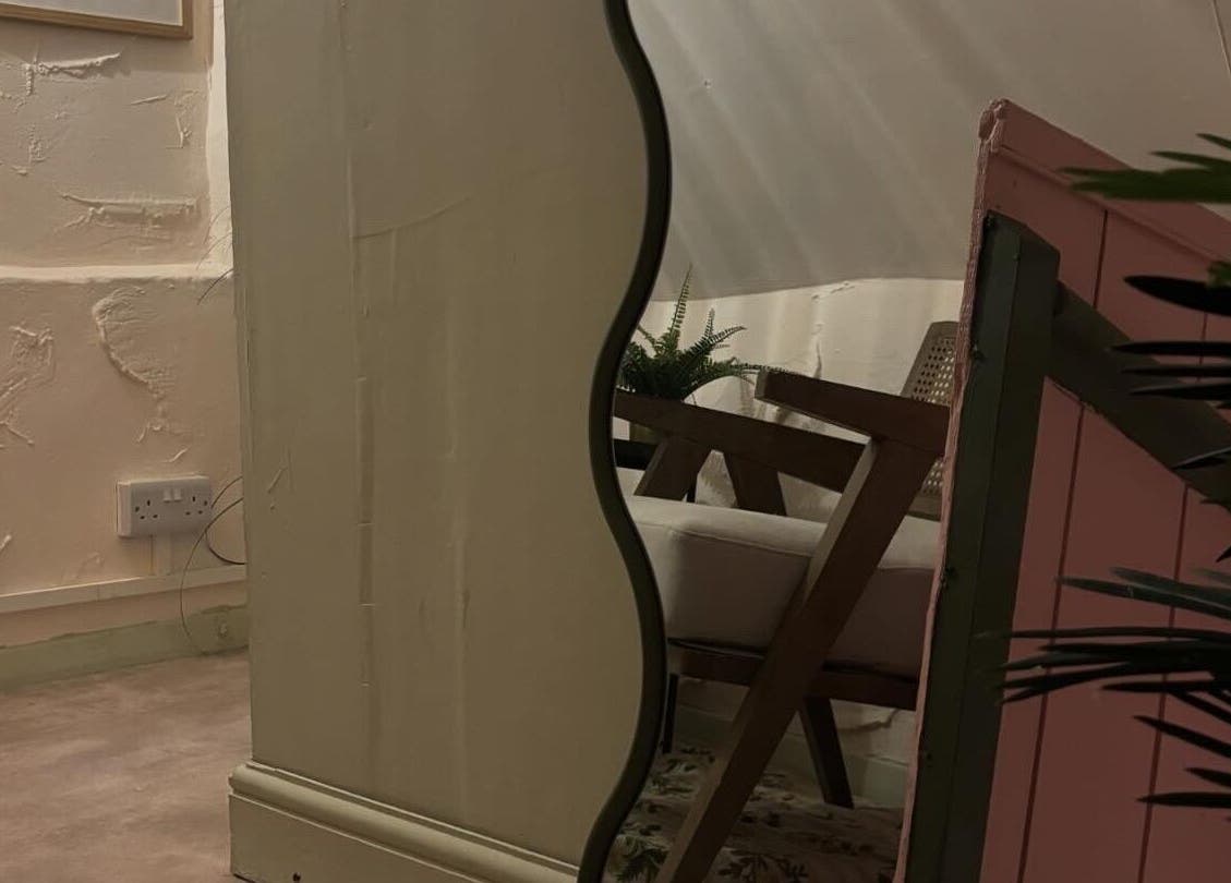 Elegant interior at Nicole at Sage and Blush, Grantham, England, GB, featuring a stylish mirror and cozy seating.