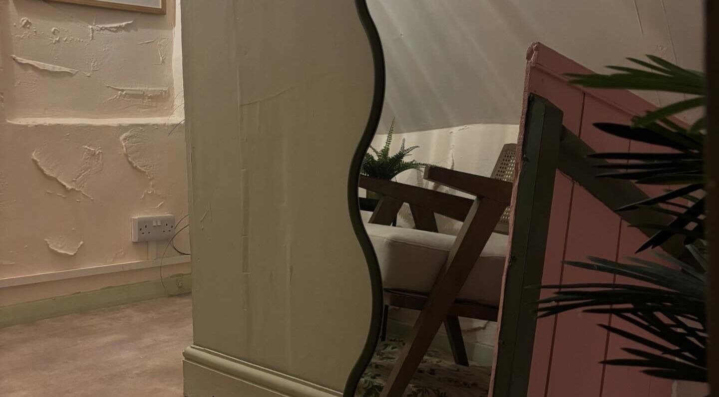 Elegant interior at Nicole at Sage and Blush, Grantham, England, GB, featuring a stylish mirror and cozy seating.