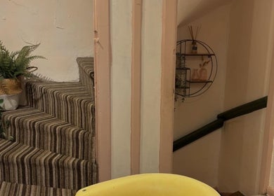 Stylishly decorated staircase at Nicole at Sage and Blush, Grantham, England, GB featuring potted plants.