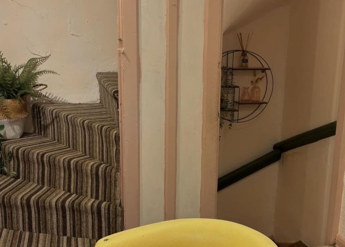 Stylishly decorated staircase at Nicole at Sage and Blush, Grantham, England, GB featuring potted plants.