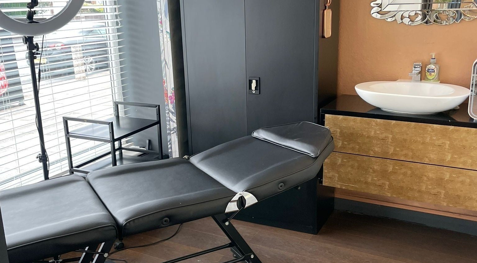 Modern treatment room at Queen Lashes in Leicester, England, GB with a sleek chair and stylish decor.