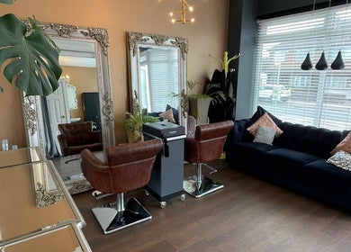 Chic salon interior at Queen Lashes, Leicester, England, GB, featuring stylish chairs and a plush sofa.