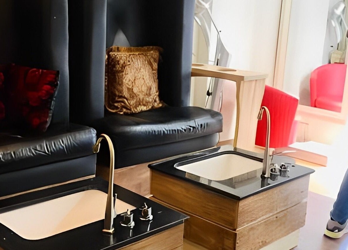 Luxurious pedicure area at Studio Stylish in Lagos, Lagos, NG, featuring plush seating and sleek basins.