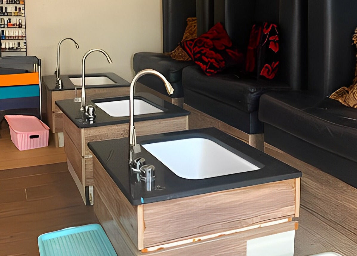 Modern pedicure setup at Studio Stylish, Lagos, Lagos, NG with plush seating and vibrant decor.