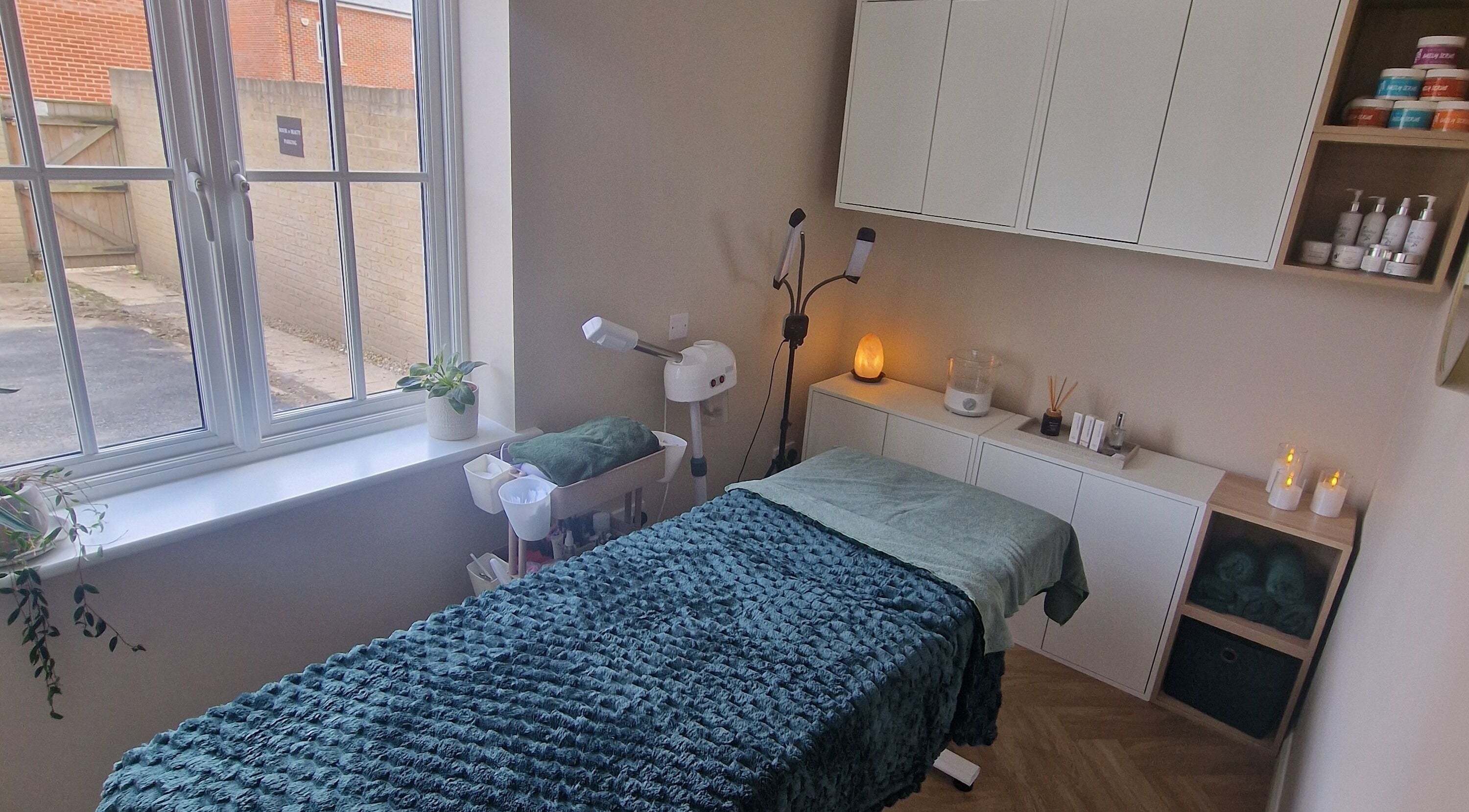 Relaxing treatment room at Dolled Up Framlingham, Framlingham, England, GB, featuring a plush massage table.