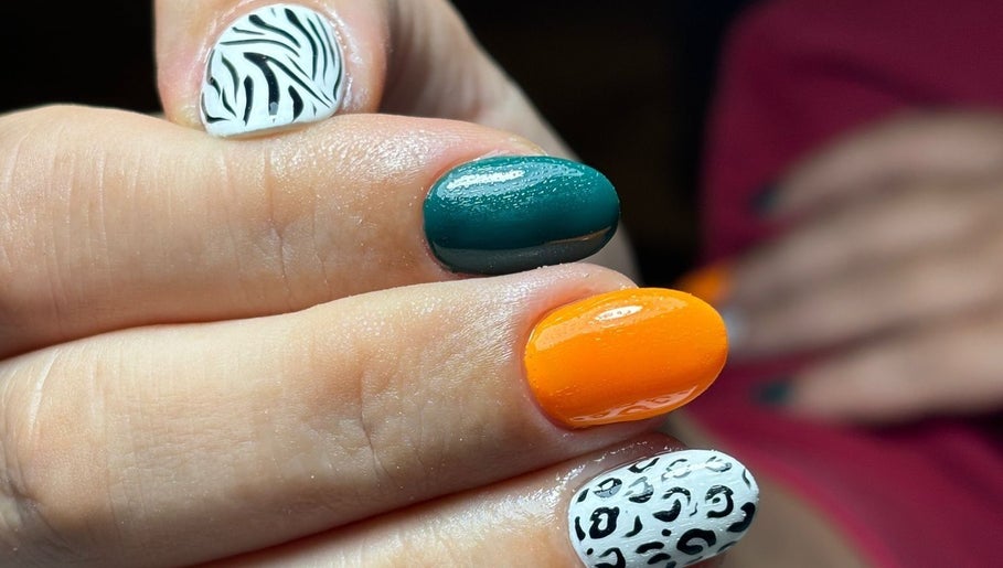 Colorful nail art at Bombshell Nail Bar 2 in Sliema, MT featuring zebra and leopard designs.