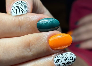 Colorful nail art at Bombshell Nail Bar 2 in Sliema, MT featuring zebra and leopard designs.