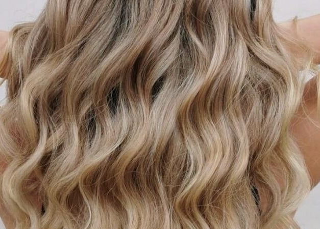 Luxurious wavy blonde hairstyle at Bombshell Nail, Hair & Beauty Bar Malta, Tas-sliema, MT.