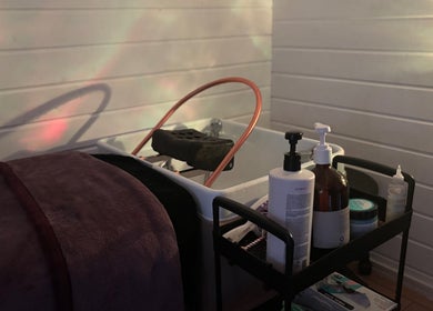 Relaxing beauty setup at Kerashine, Beith, Scotland, GB with premium skincare products and a luxurious towel.