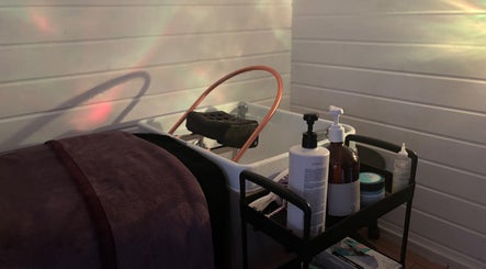 Relaxing beauty setup at Kerashine, Beith, Scotland, GB with premium skincare products and a luxurious towel.