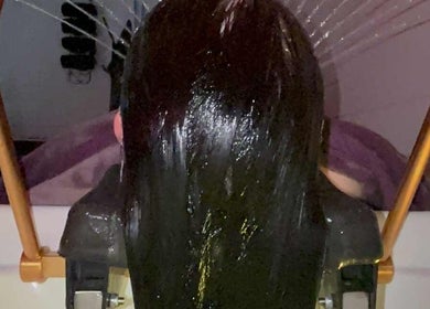 Luxurious hair treatment at Kerashine, Beith, Scotland, GB, showcasing a sleek hair rinse.
