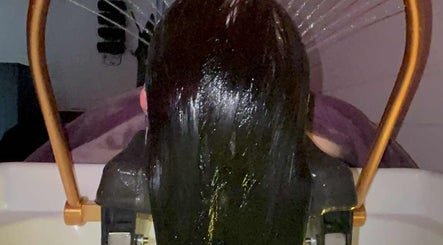 Luxurious hair treatment at Kerashine, Beith, Scotland, GB, showcasing a sleek hair rinse.