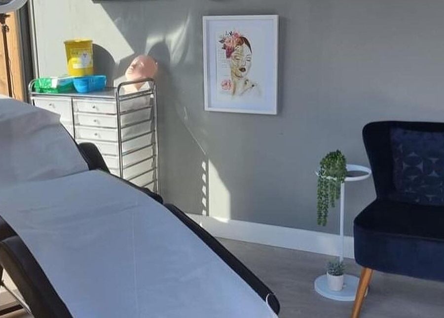 Calm treatment room at Bay Beauty Academy, Whitley Bay, England, GB with a therapy bed and cozy seating.