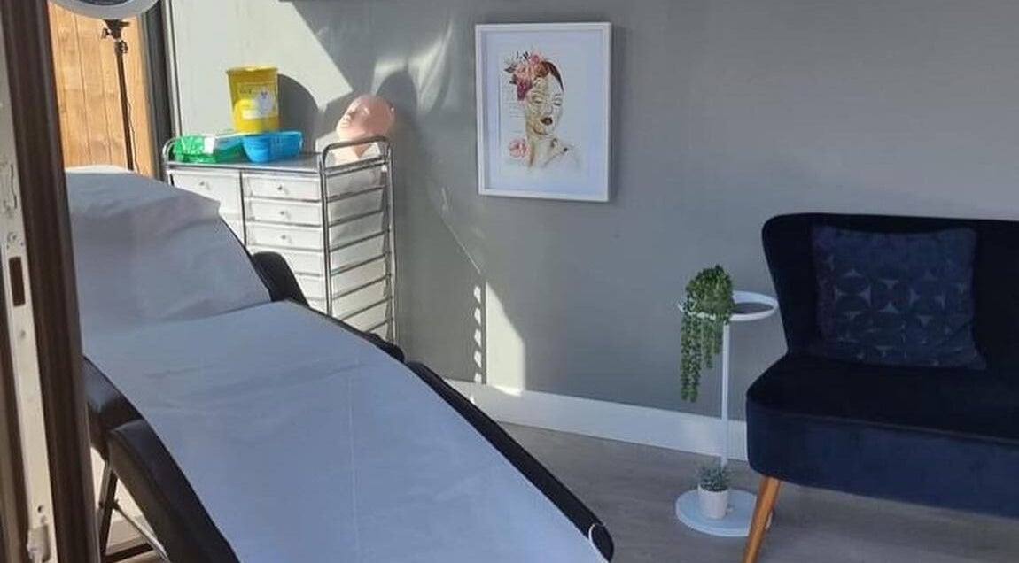 Calm treatment room at Bay Beauty Academy, Whitley Bay, England, GB with a therapy bed and cozy seating.