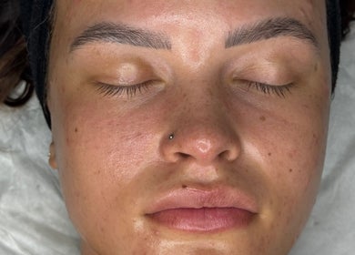 Close-up of a relaxed face post facial at Glossom Beauty, Motherwell, Scotland, GB. Smooth, rejuvenated skin.