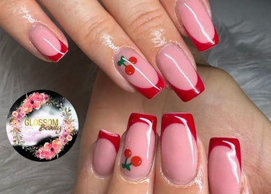 Elegant red french tips with cherry nail art at Glossom Beauty, Motherwell, Scotland, GB.