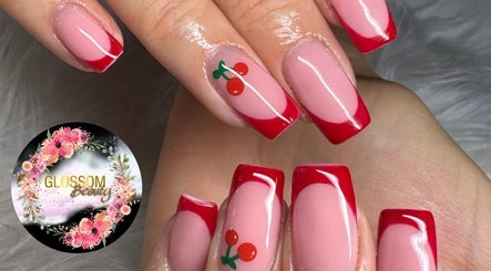 Elegant red french tips with cherry nail art at Glossom Beauty, Motherwell, Scotland, GB.