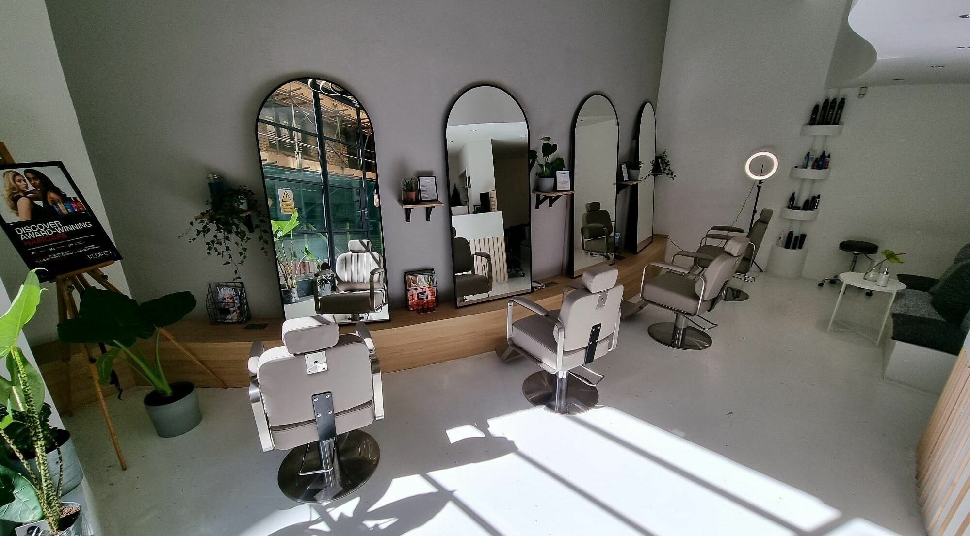Interior of K&Co Hair Salon showcasing modern chairs and mirrors in London, England, GB.